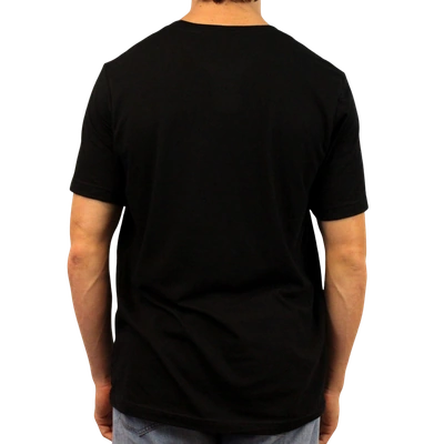 A person stands with their back to the camera, wearing the “Gaslighting Is Not Real You're Just Crazy” T-shirt in plain black and light blue jeans against a white background.