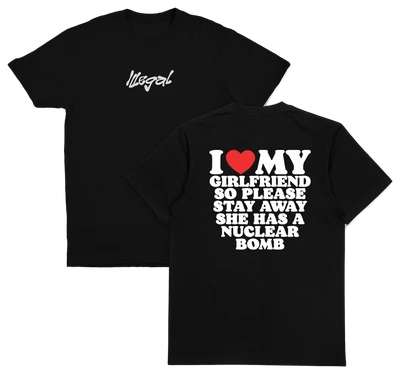 Two black I Heart My Girlfriend So Please Stay Away She Has A Nuclear Bomb T-Shirts (Backprint), made from 175 GSM ethically grown cotton; “Illegal” in white script on the front, bold back text: I ♥ MY GIRLFRIEND SO PLEASE STAY AWAY SHE HAS A NUCLEAR BOMB.