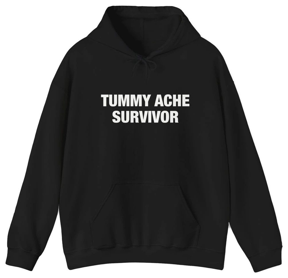 The Tummy Ache Survivor Hoodie is a black cotton-polyester sweatshirt with "TUMMY ACHE SURVIVOR" on the chest, front pocket, drawstring hood, and is part of our signature Illegal Shirts collection.