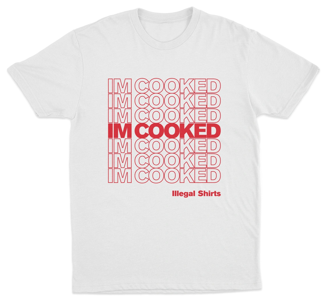 The I'm Cooked T-Shirt features repeated red "IM COOKED" text in a grid with the center row bolded. "Illegal Shirts" appears below in smaller red text. Stand out with this fun and unique design!.