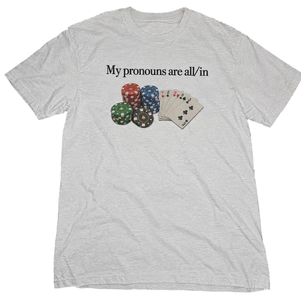 My Pronouns Are All/In T-Shirt — Laid-out view (AI-generated styled mockup)